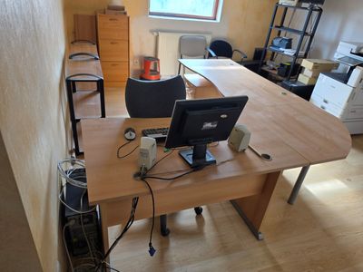 a desk with two computers on it in a room