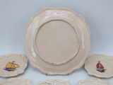 four plates and a plate with a picture of a boat on them