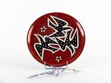 a red plate with black and white designs on it