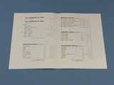 an open book with a list of items on it on a blue surface