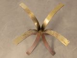 a metal sculpture of a flower that is on the floor
