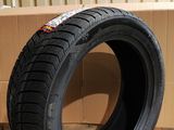 tire on the ground next to a cardboard box in a warehouse