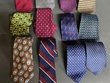 several different colored ties laid out in a row on a table