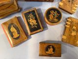 many small wooden boxes with pictures on them on a table