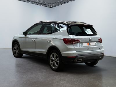 an image of a silver car parked in a showroom