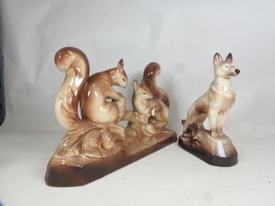 two figurines of a cat and a dog on a table