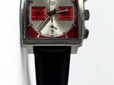 a close up of a watch on a white surface