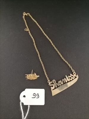 a close up of a necklace and a tag on a table