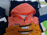 a lot of clothes that are sitting on a table