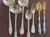 a lot of silver spoons and spoons on a table
