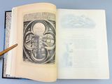 an open book with a drawing of a clock on it