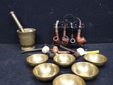 many brass bowls and other items on the table