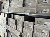 many boxes of electronic equipment on the shelves in the store