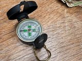 a compass on a table with money on the table