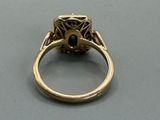 an image of a gold ring with a black diamond