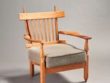 an image of a wooden chair with a cushion on top of it