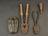 several tools are laid out on a table, including a pair of pliers and a knife