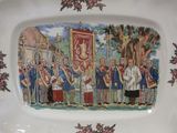 a plate with a picture of a group of people on it