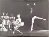 black and white photograph of a ballerina in a tutu with other dancers in the background