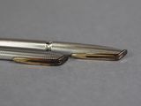 a close up of a pen and a ballpoint pen on a table