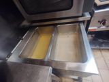 two pans that are sitting in the middle of a stove