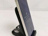 a cell phone that is on a stand on a table