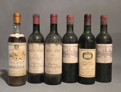 several bottles of wine are lined up on a table