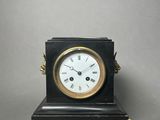a small clock that is sitting on top of a table