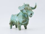 statue of a bull on a white surface with a white background