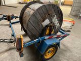 an image of a large wooden cable reel on a trailer