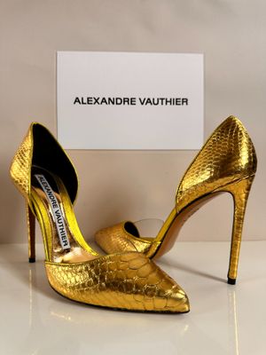 a close up of a pair of gold shoes on a table