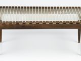 the table is made of wood and has a woven top