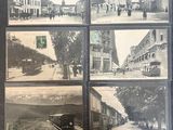 a black and white photo of a street with old buildings
