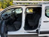 a white van with its doors open in a parking lot