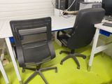 two chairs and a desk with a computer on it