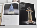 an open book with a picture of a statue on it