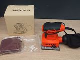 black and decker orbital sander with box and accessories on a table