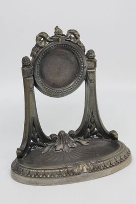 a silver statue of a mirror with birds on it