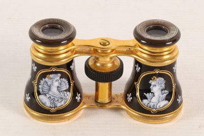 a gold and black binoculars with pictures of people on it