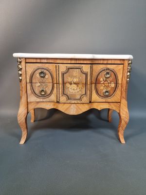 a small wooden chest with three drawers and a marble top
