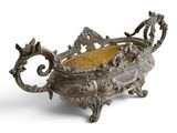 an antique silver plated bowl with a handle and handles