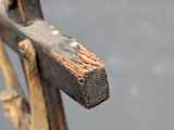 a wooden cross with a piece of wood sticking out of it