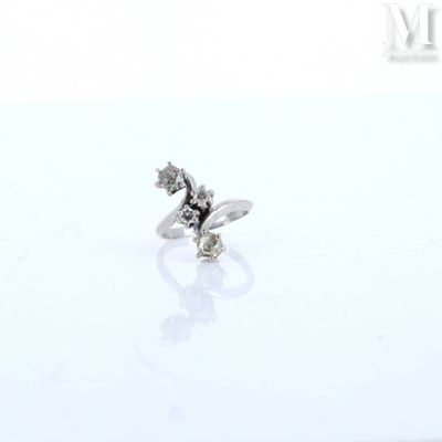 an image of a diamond ring sitting on top of a white surface
