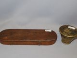 a small wooden box and a small metal container on a table