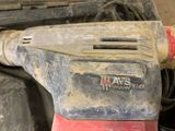 a close up of a sander on a table in a garage