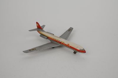 a toy airplane that is sitting on a white surface
