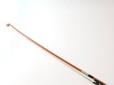 a close up of a violin bow on a white surface