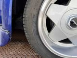 a close up of a tire on a blue truck