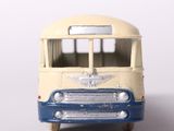 a toy bus that is sitting on a white surface