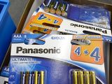 many piles of batteries in a box on the floor